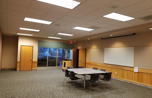 Hatfield Community Room. One table with chairs in a large room.