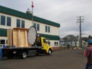 large clock with truck and construction workers